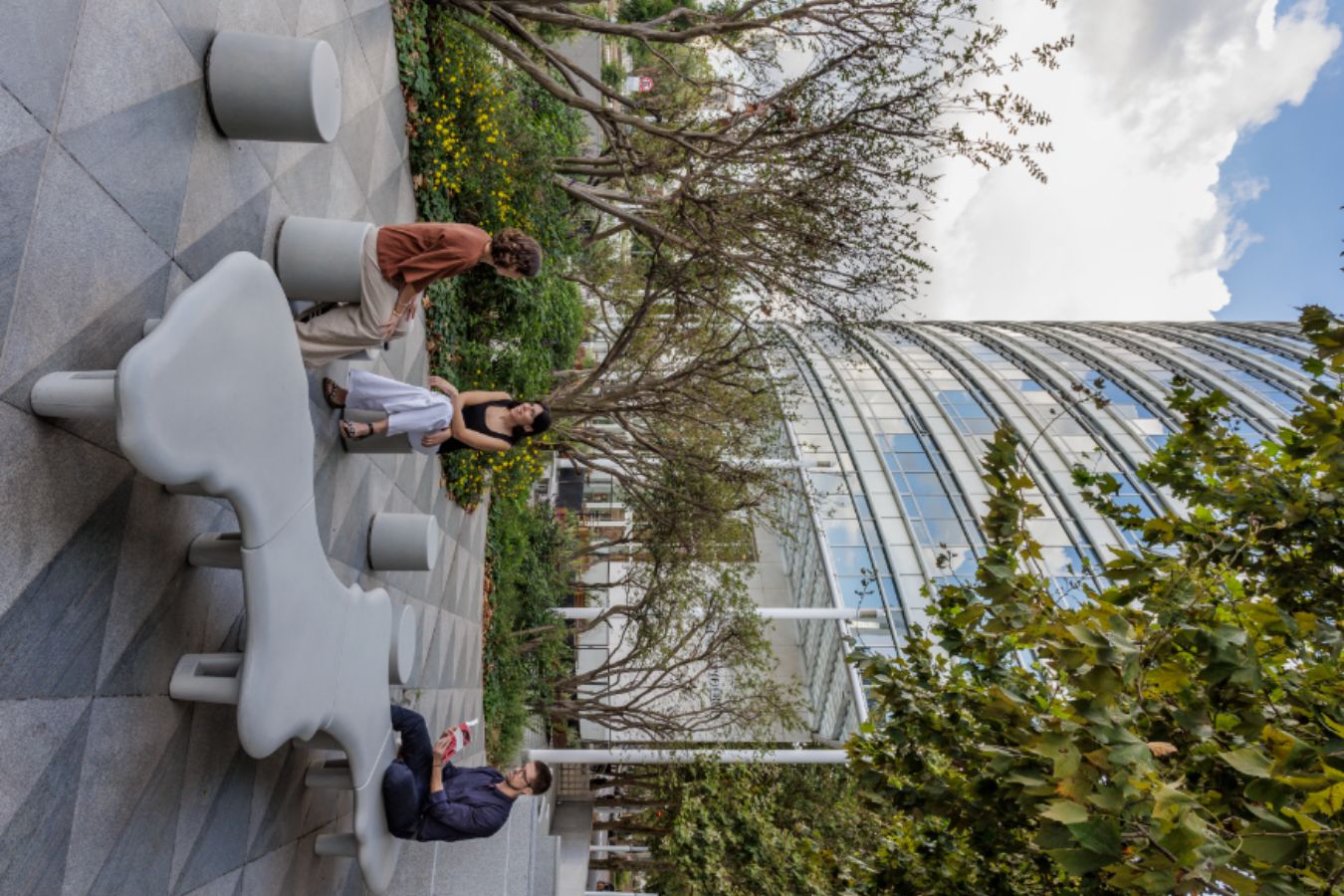 Edificio Republica - Exterior breakout zone with sculptural concrete furniture and glass facade view - Contract Workplaces.jpg